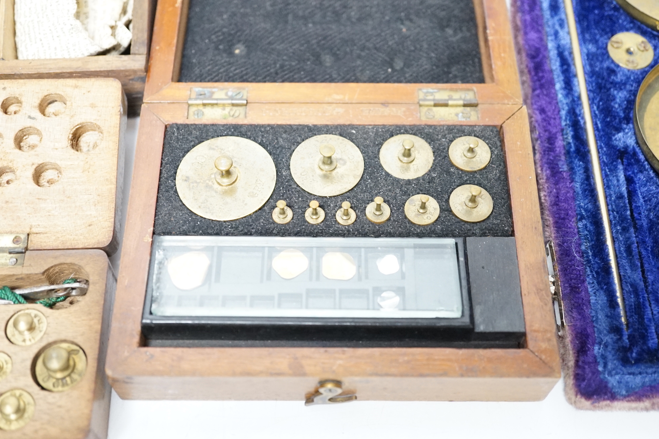 Four cased weighing sets, three of the sets with small scales included